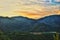 Golden sunset over hills and a lake