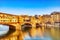 Golden Sunset over Ponte Vecchio Bridge with Reflection in Arno River, Florence