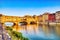 Golden Sunset over Ponte Vecchio Bridge with Reflection in Arno River, Florence