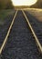 Golden Sunset and Rural Railroad Tracks Vanishing into Distance