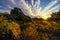 Golden sunset with sunbeams illuminating the large rocks,