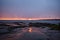 Golden sunset, turbines and rocky shore