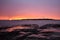 Golden sunset, turbines and rocky shore