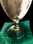 Golden sweat covered glass goblet on green napkin