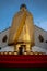 A golden tall Buddha standing at wat Intharawihan.