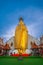 A golden tall Buddha standing at wat Intharawihan.