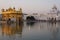 The Golden Temple at Amritsar, Punjab, India, the most sacred icon and worship place of Sikh religion. Sunset light reflected on l