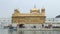 Golden temple in Amritsar, with water in front, closeup.