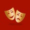 Golden theatrical masks of comedy and tragedy on red background