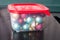 Golden, tiffany and burgundy Christmas balls packed for keeping in a transparent plastic food container with red cover
