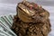 Golden toad with coins sits on money close-up.