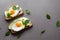 Golden toast with avocado and chicken egg and basil leaves