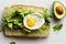 Golden toast with avocado chopped greens and fried egg