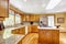 Golden tones kitchen interior with island and skylight