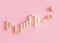 Golden trading chart with coins and copy space. Stock trade data on graph with japanese sticks, pink background. Trading