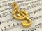 Golden treble clef on score paper