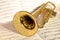 Golden trumpet lying on sheet music
