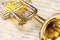 Golden trumpet on sheet music with scenic reflections and lens flare