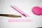 Golden tweezers, microbrush, finished bundles, pink brushes, eye patches