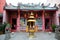 Golden urn and guard lions at entrance to Chinese temple Kuching Sarawak Malaysia