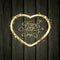 Golden Valentine heart with diamonds on black wooden background