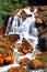 Golden Waterfall flowing over rust-colored rocks & soil due to minerals from a former mining area in Taipei,