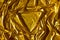 Golden wavy abstract background from a luxurious fabric, wavy folds, in the center a place for your gift in the form of