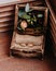 Golden wedding rings in the beautiful rustic box with flowers inside and on the wooden background