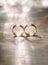 Golden wedding rings with shining bokeh on wooden surface, eternal love concept