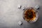 Golden whiskey in glass with cooling stones on table, top view.