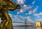 Golden Winged Statue at The Historic River Street Waterfront With The Tallmadge Bridge
