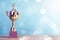 Golden winner`s trophy on sky background standing on wooden desk festive bokeh blur background