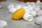 Golden yellow cocoons stand out among the white cocoons on a bamboo tray.