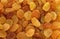 Golden yellow raisins background