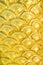 Golden yellow serpent scale statue texture with seamless patterns for background