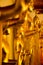 Golden yellow statue of Buddha standing meditating and praying