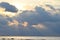 Golden Yellow Sunrays Coming from Dark Grey Clouds with Warm Colors in Sky and Still Sea Water - Neil Island, Andaman, India