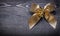 Goldish bow on wooden board holiday concept