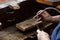 goldsmith jeweler soldering a silver ring on the workbench with a soldering.