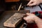 goldsmith jeweler soldering a silver ring on the workbench with a soldering.