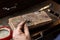 goldsmith jeweler soldering a silver ring on the workbench with a soldering.