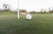 Golf ball close to cup hole on putting green