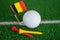 Golf ball with Germany flag and tee on green lawn or grass is most popular sport in the world