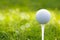 Golf ball on green grass bokeh background