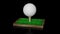 Golf ball on green turf patch