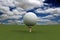 Golf ball over blue sky