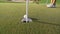 A golf ball rolls into a pocket on a green field. Close-up
