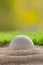 Golf ball in sand bunker near the lawn