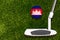 A golf club and a ball with flag Cambodia during a golf game