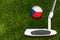 A golf club and a ball with flag Czech during a golf game